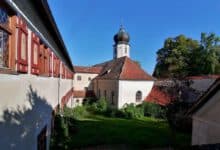 Idyllischer Innenhof des Klosters mit Blick auf den Kirchturm